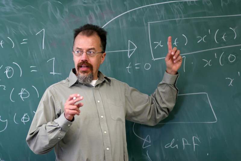 a man in front of a chalkboard
