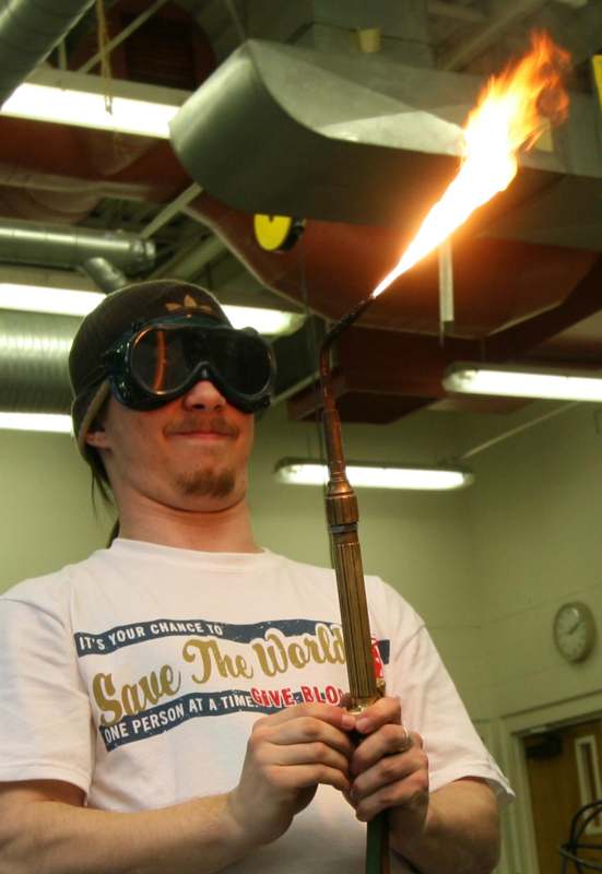 a man wearing goggles and holding a torch