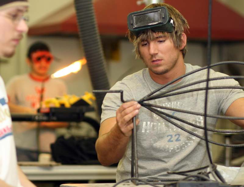 a man wearing goggles and holding wires