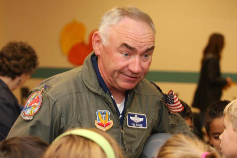 a man in a uniform with patches on his shoulders