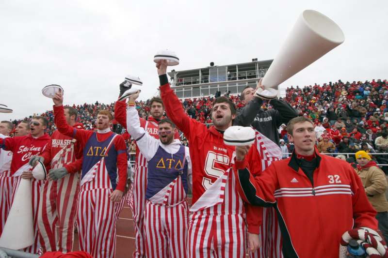 a group of people in striped uniforms holding megaphone