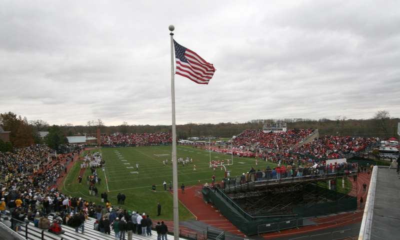 a flag flying on a flagpole on a football field