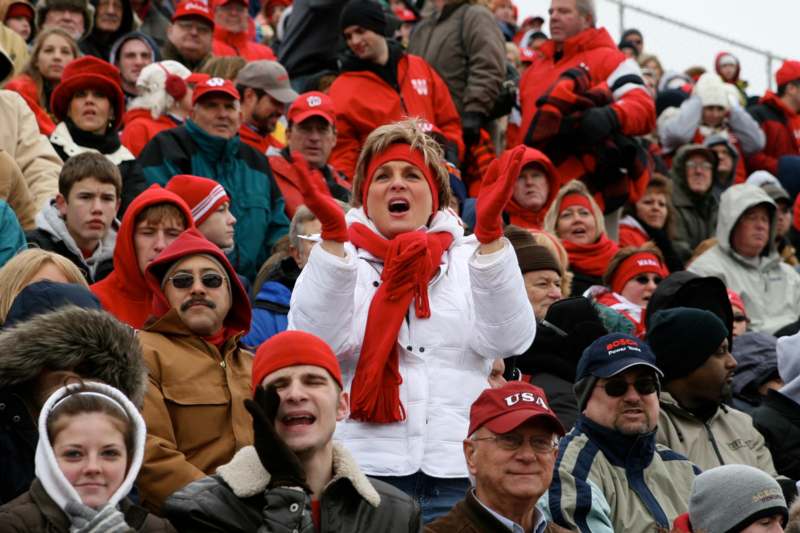 a group of people in red hats and hats