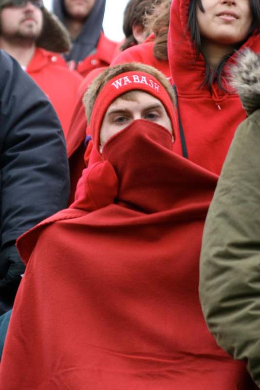 a man wrapped in a red blanket