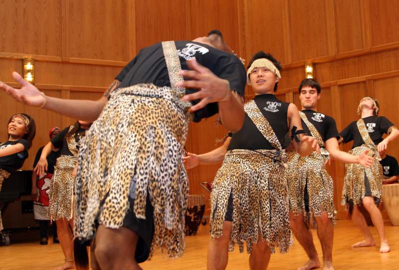 a group of men wearing leopard print skirts