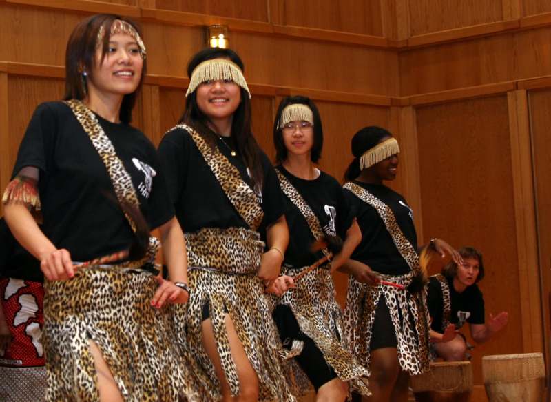 a group of women wearing leopard print skirts and matching headbands