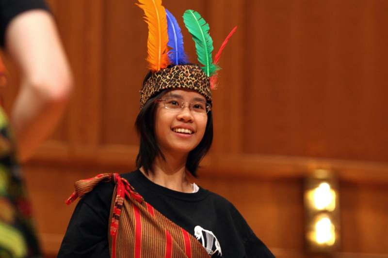 a woman wearing a feather headband