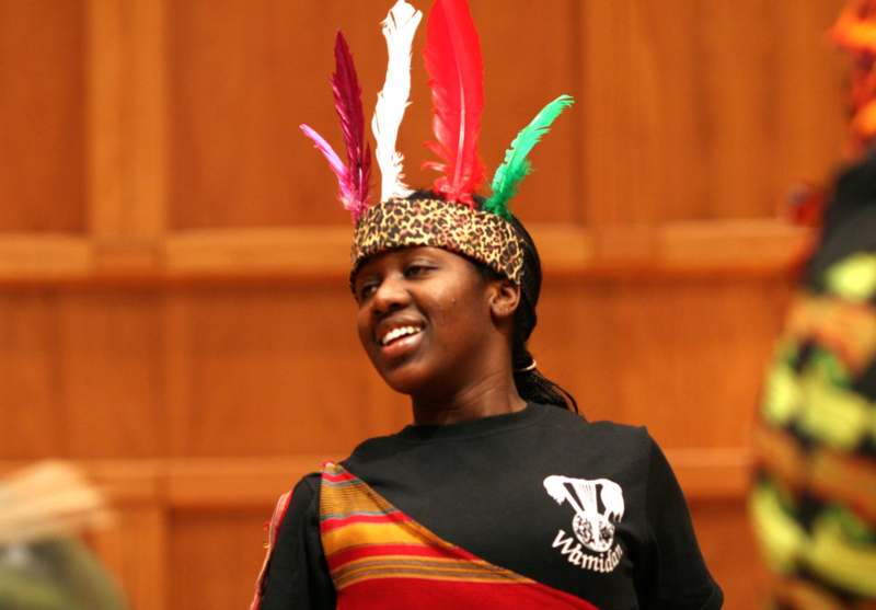 a woman wearing a headband with feathers