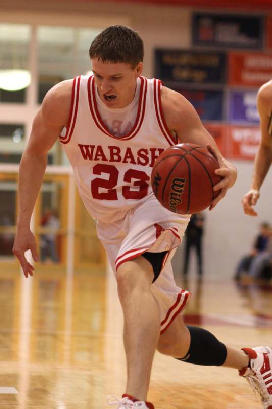 a man in a basketball uniform with a basketball