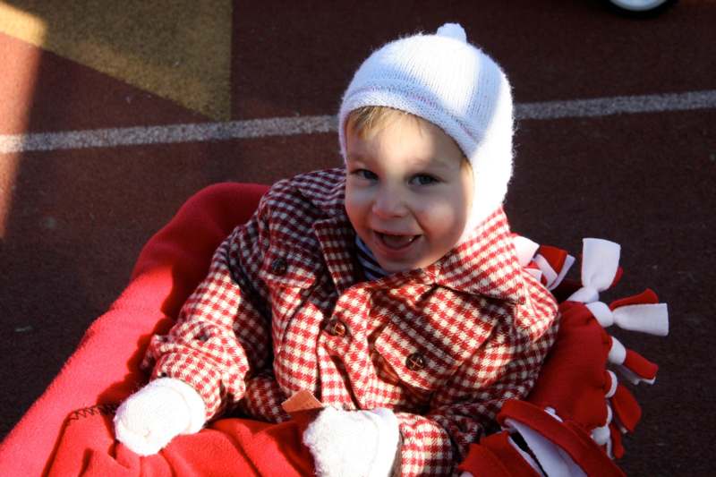 a child in a red and white coat and hat
