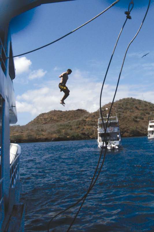 a man jumping off a boat