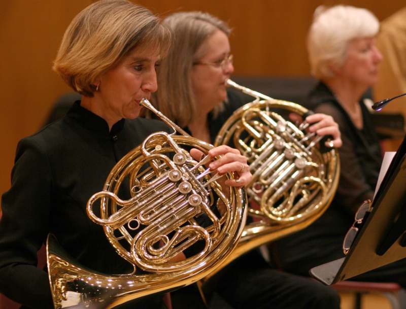 a group of women playing french horn