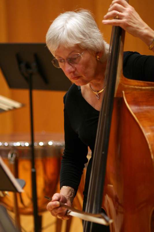 a woman playing a double bass