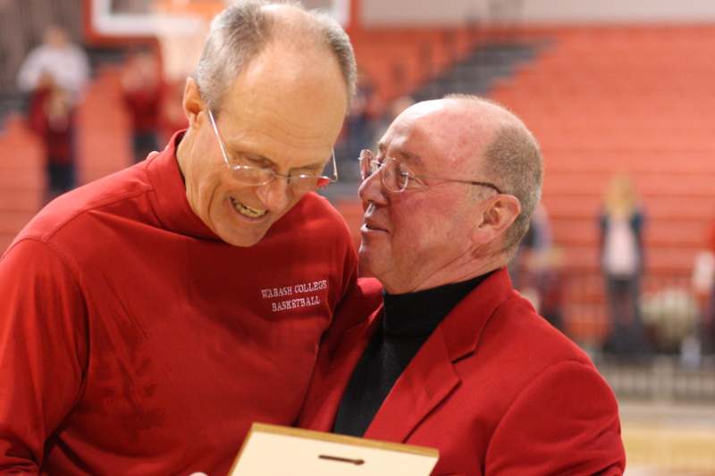 a pair of men in red jackets