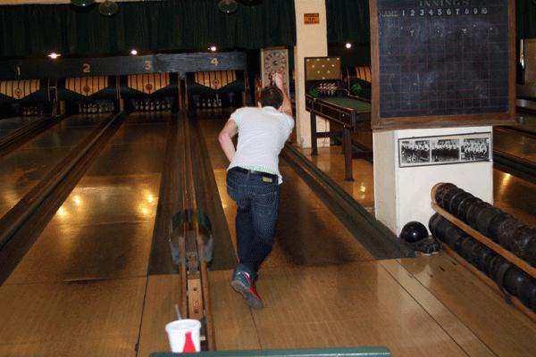 a man bowling on a lane