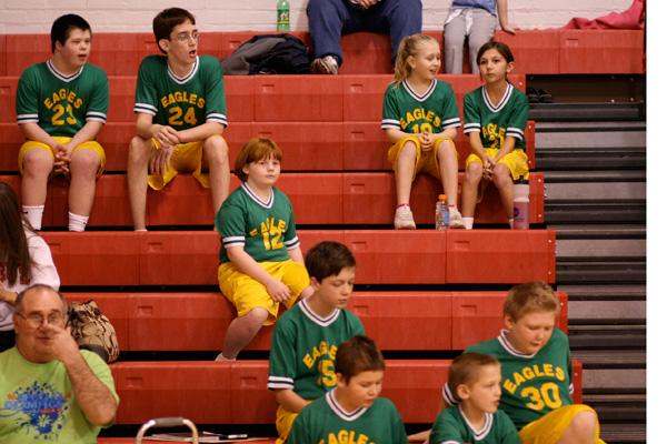 a group of kids sitting on bleachers