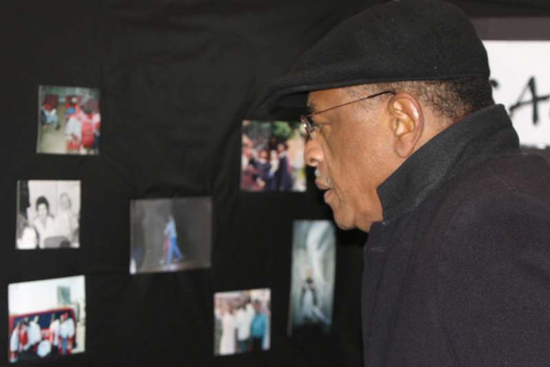 a man looking at pictures on a wall