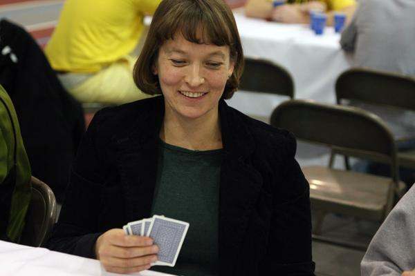 a woman holding playing cards