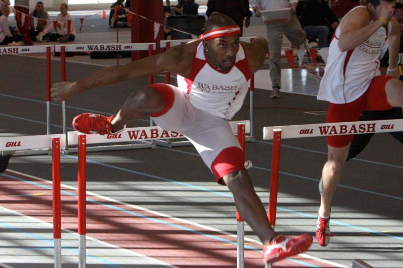 a man jumping over hurdles