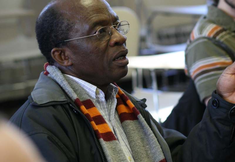 a man wearing glasses and a scarf