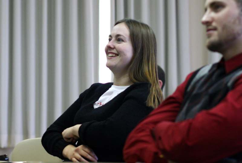 a woman smiling and sitting in a room