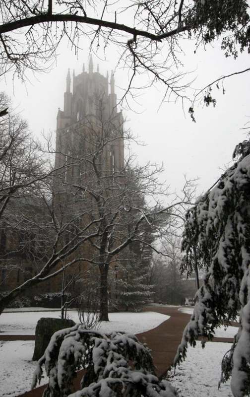 a snowy landscape with a tall tower