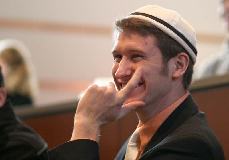 a man wearing a hat and smiling