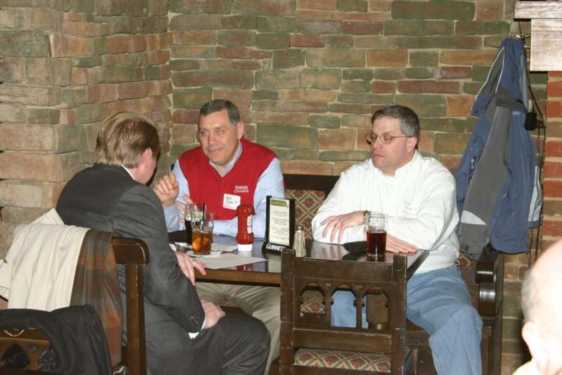 a group of men sitting at a table