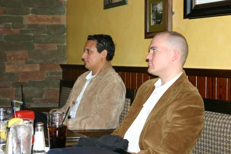 a couple of men sitting at a table