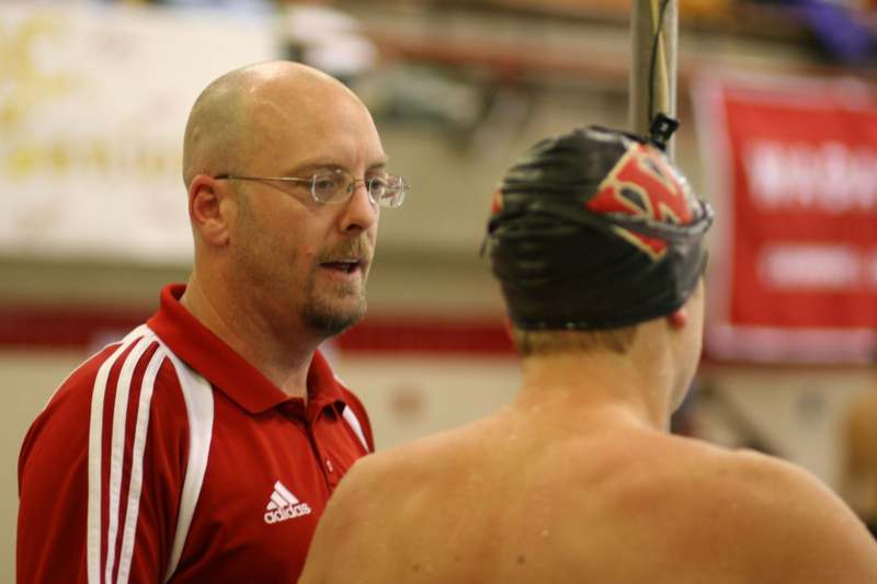 a man talking to a swimmer