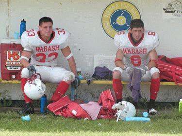 football players sitting on a bench