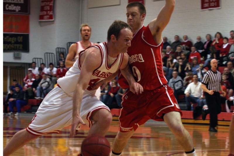a basketball player in red uniform dribbling a basketball