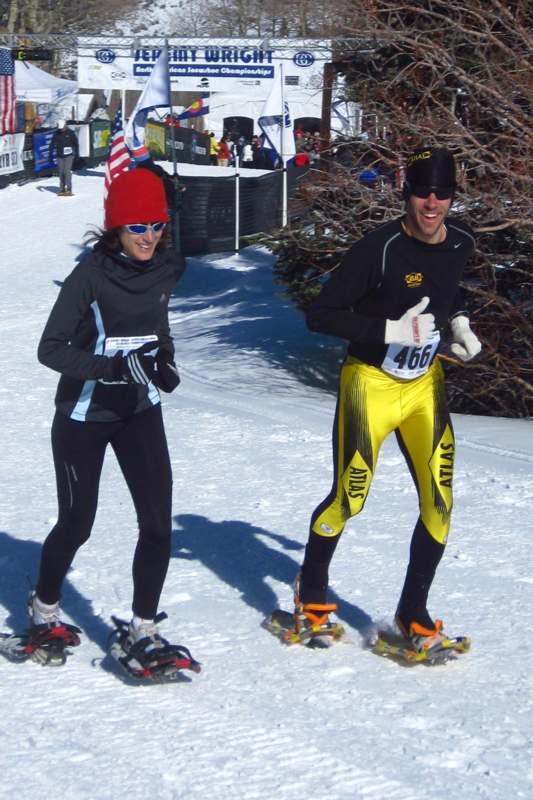 a man and woman in snow shoes