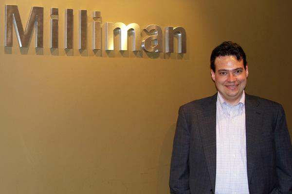 a man standing in front of a sign