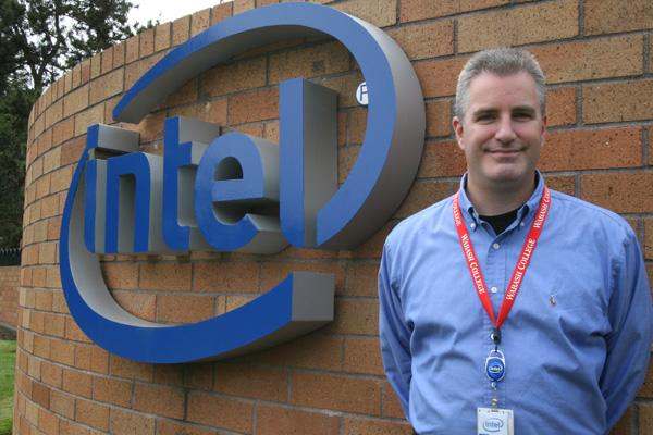a man standing in front of a sign