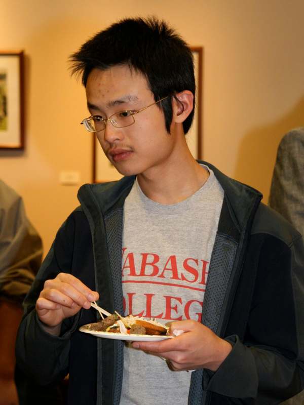 a man eating food with chopsticks