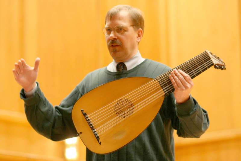 a man playing a lute
