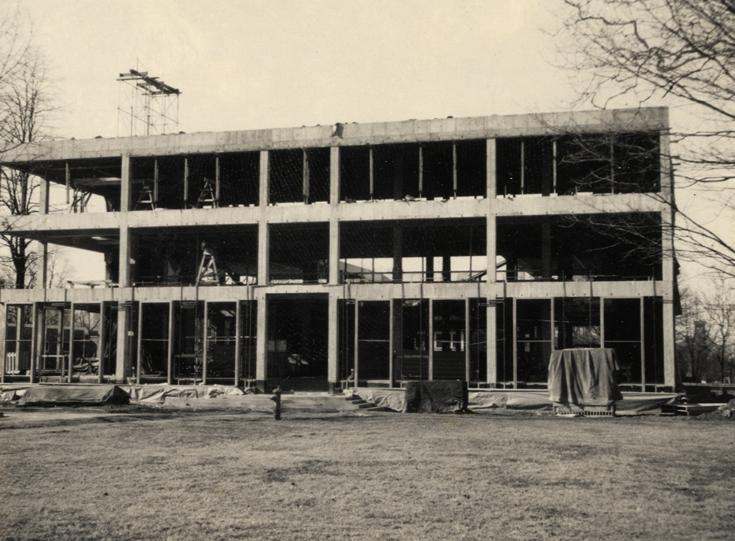 a building under construction with a grass field