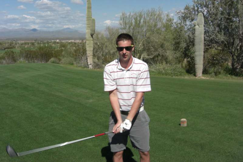 a man holding a golf club