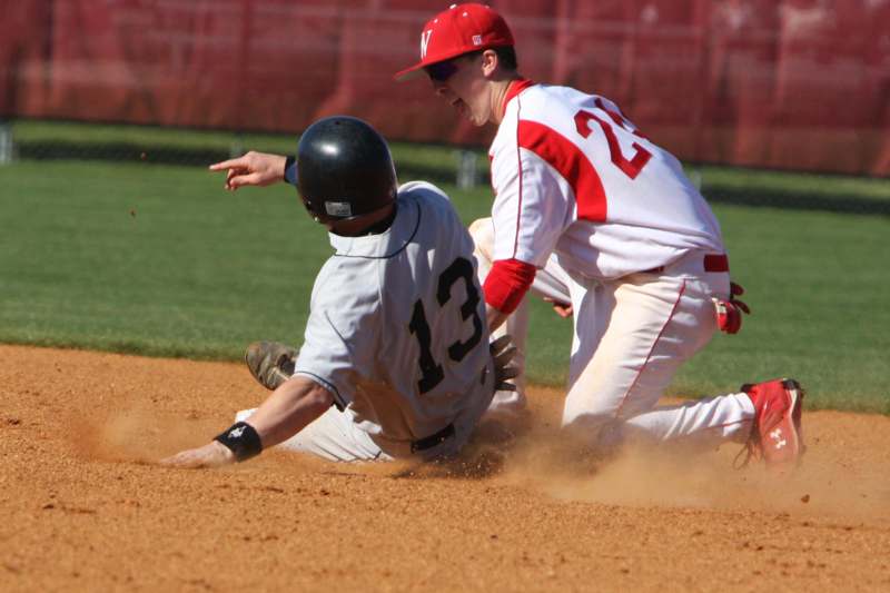 a baseball player sliding into the ground