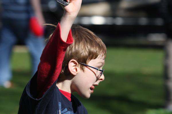a boy raising his hand