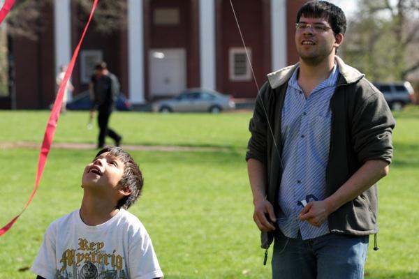 a man and boy flying kites