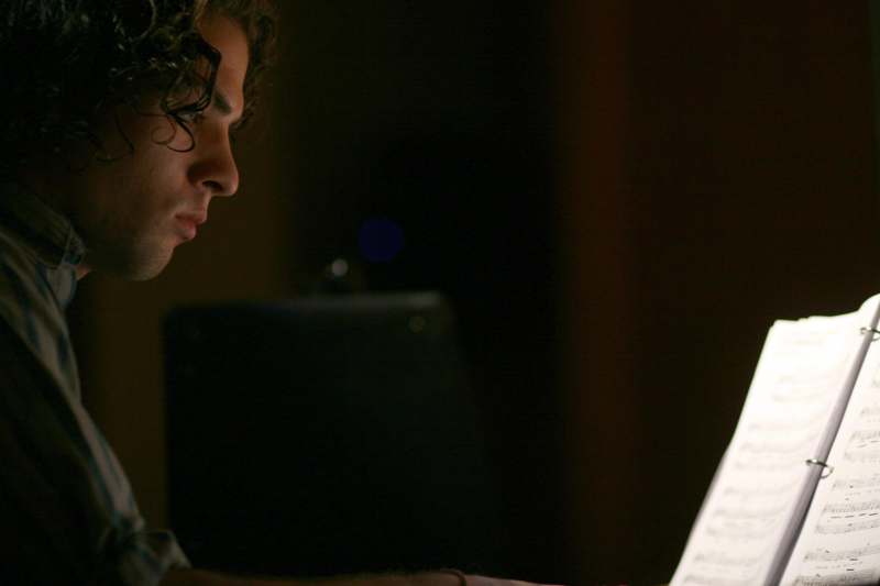 a man looking at a sheet music
