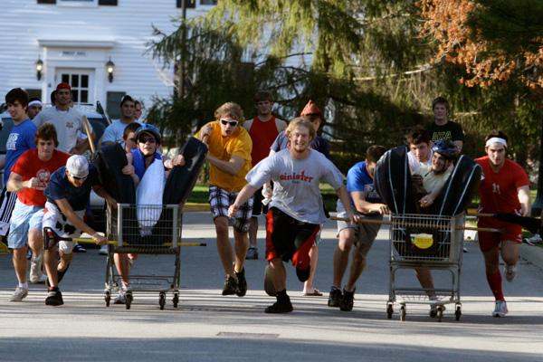 a group of people pushing shopping carts