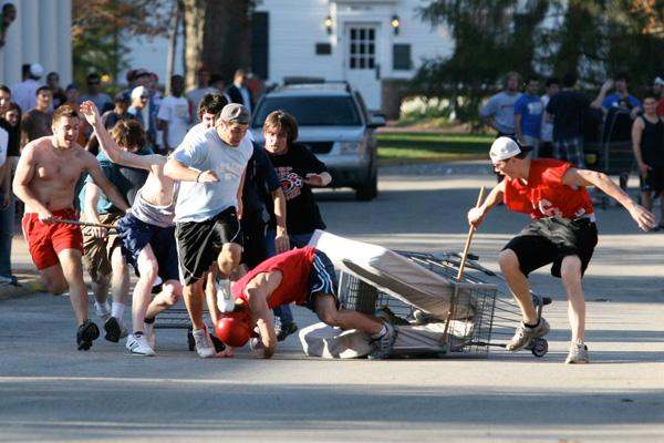 a group of people pushing a cart