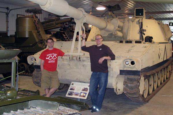men standing next to a tank
