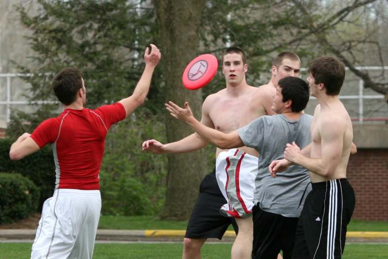 a group of men playing with a frisbee