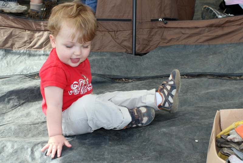 a child sitting on a tarp
