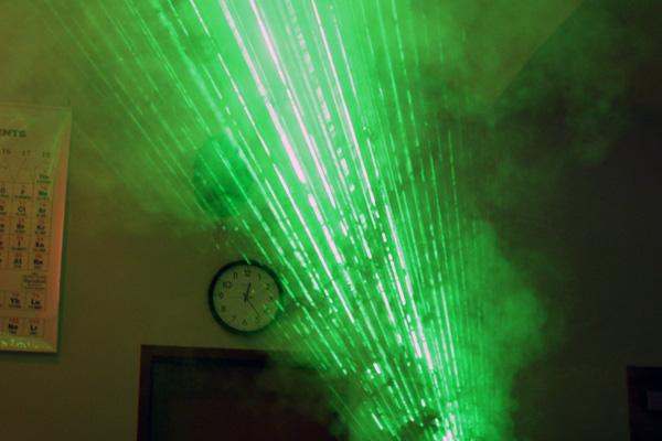 a green laser beam in the dark