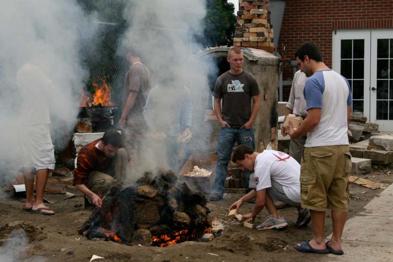a group of men around a fire